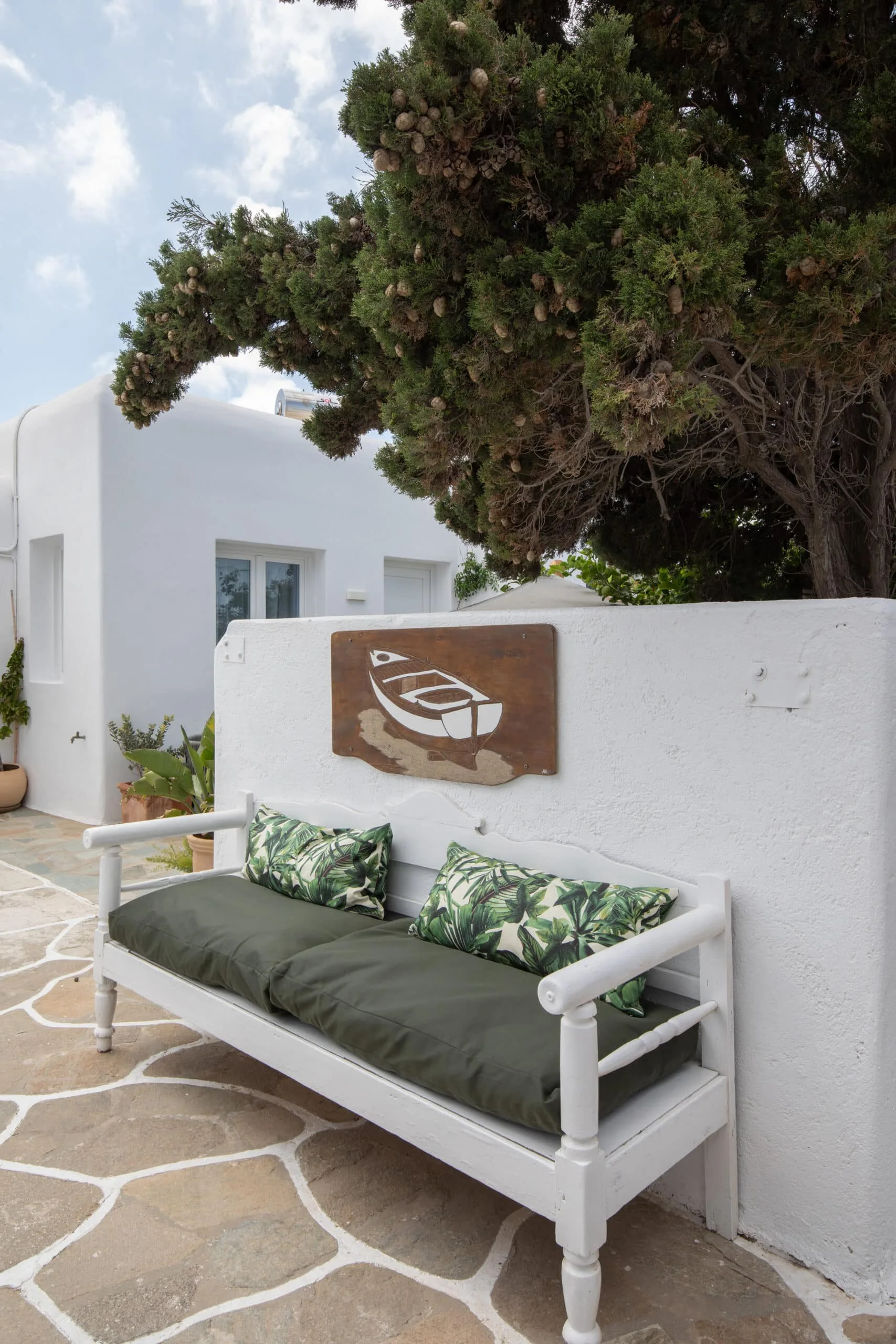 Garden bench in the courtyard under a cypress tree